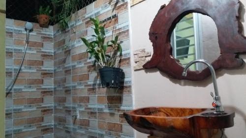 a bathroom with a wooden sink and a mirror at Kota's House Homestay in Hue