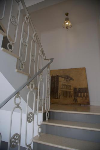 a set of stairs with a painting on the wall at Masnadieri 18 in Parma