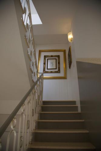 a stairway with a picture on the wall at Masnadieri 18 in Parma