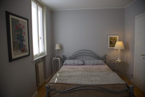 a bedroom with a bed in a room with a window at Masnadieri 18 in Parma