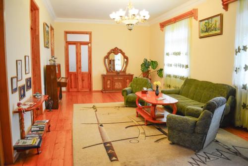 a living room with a couch and a table at Guest house Nataly in Yeghegnadzor