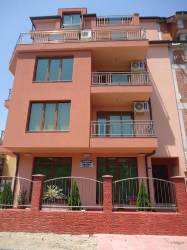 a building with balconies on the side of it at Adri Guest House in Nesebar