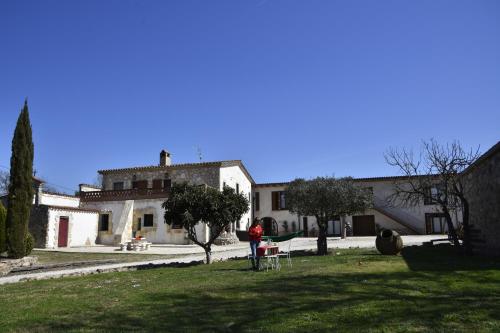 a person standing in a yard in front of a building at B&B El Ranxo in Franciach