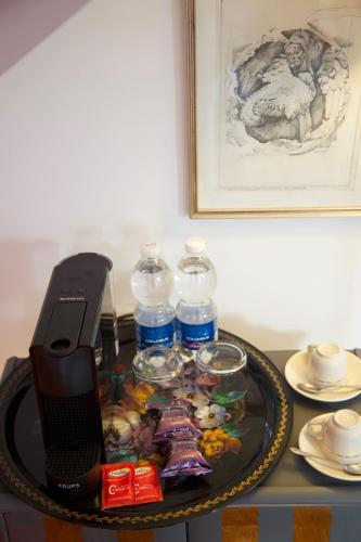 a table with a phone and water bottles on it at Masnadieri 18 in Parma