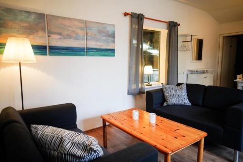 a living room with two couches and a coffee table at Lindenhof Habernis in Steinberg