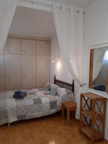 a bedroom with a bed and a mirror at Apartamentos El Tosal 7E in Calpe
