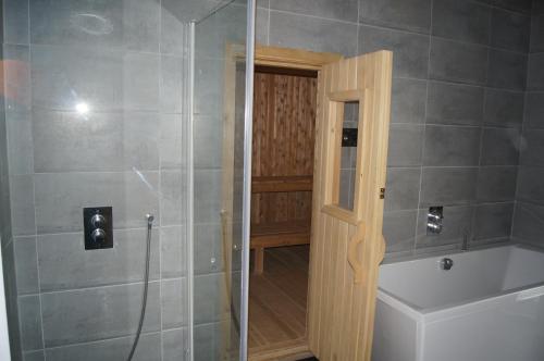 a bathroom with a shower and a toilet and a sink at Guesthouse Nordheimar in Selfoss