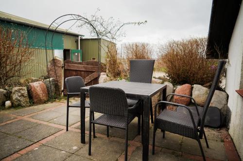a black table and chairs on a patio at Lindenhof Habernis in Steinberg