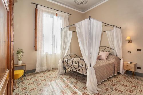 a bedroom with a bed with a canopy at Villa Ricci Suites in Lucca