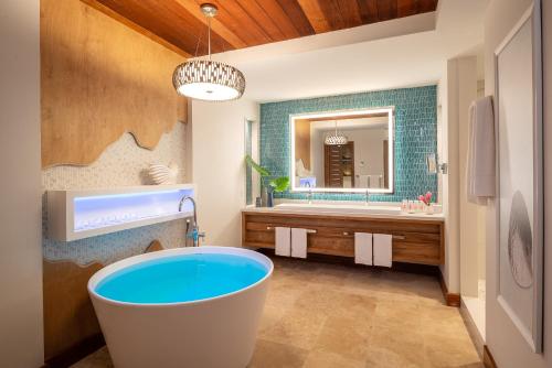a bathroom with a large tub and a large sink at Sandals Montego Bay All Inclusive - Couples Only in Montego Bay