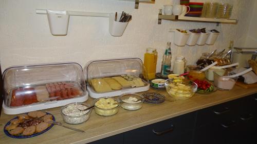a kitchen counter with some food on a table at Pension "Lug ins Land" in Kurort Rathen