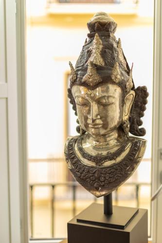a vase on a stand in front of a window at Bib Rambla Luxury Apartments in Granada