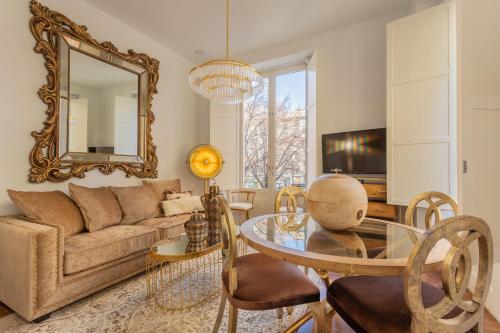 a living room with a couch and a table with a mirror at Bib Rambla Luxury Apartments in Granada