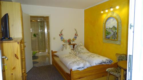 a bedroom with a bed with white pillows at Pension "Lug ins Land" in Kurort Rathen