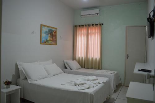 Postel nebo postele na pokoji v ubytování Hotel Confort Maringá