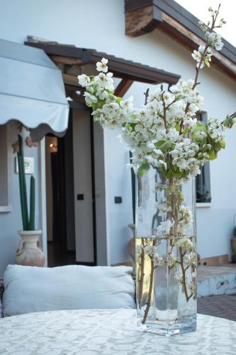 a vase filled with white flowers sitting on a table at Girelli Sorelle in Bussolengo