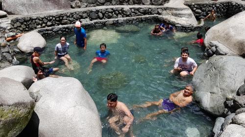 a group of people in a pool of water at Baleh Boble Guesthouse in Banaue