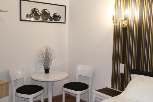 a room with a table and chairs and a bed at Lorf Hostel&Coffee in Kraków