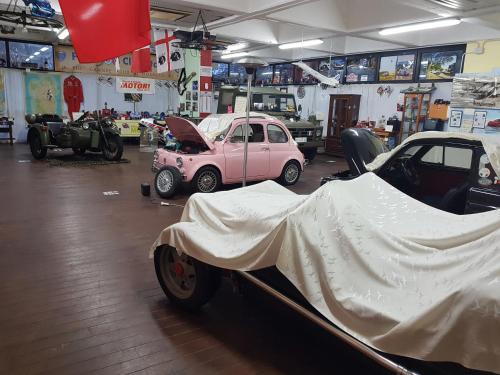 a garage with several cars parked in a room at B&B 500 Miglia  in Tempio Pausania