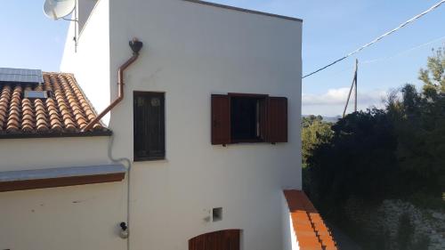 a white building with a window on the side of it at SERRA E MESU Affittacamere in Magomadas