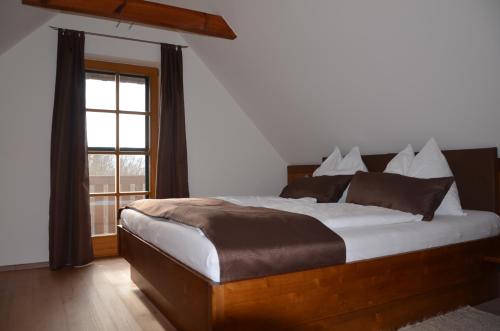 a bedroom with a large bed and a window at Kröll-Hube in Sankt Johann im Saggautal