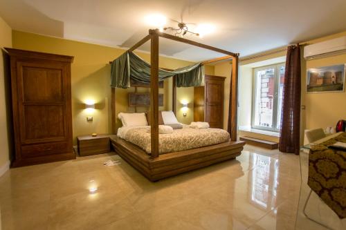 a bedroom with a canopy bed in a room at Chiaia 205 in Naples