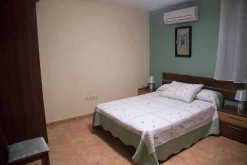1 dormitorio con 1 cama y 1 silla en Aranaz Bardenas, en Cadreita