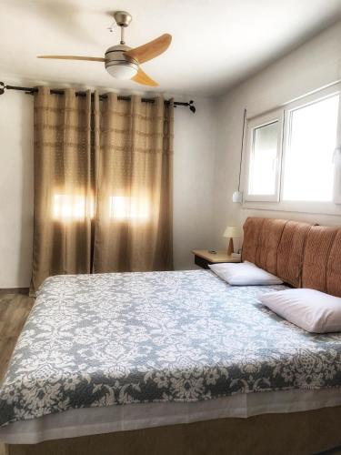 a bedroom with a bed with a ceiling fan at The Hillhouse near Alexandroupolis (Ground floor) in Alexandroupoli
