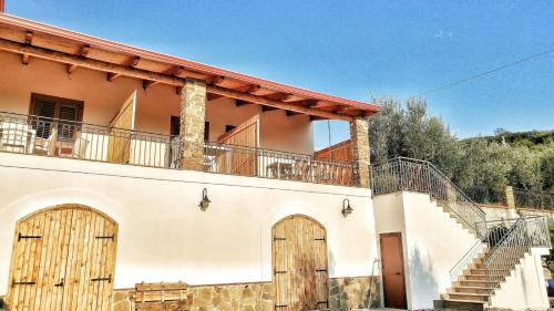 a house with two wooden doors and a staircase at Tenuta Marga in Agnone