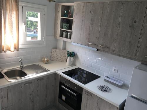 a kitchen with a sink and a stove at Liofoto Sea View Apartments in Stalida