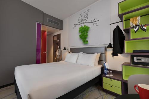 a bedroom with a large bed and a desk at Ibis Styles Jerusalem City Center - An AccorHotels Brand in Jerusalem
