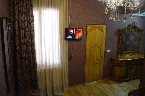 a room with a door and a window and a chandelier at Millennium Rabati in Akhaltsikhe
