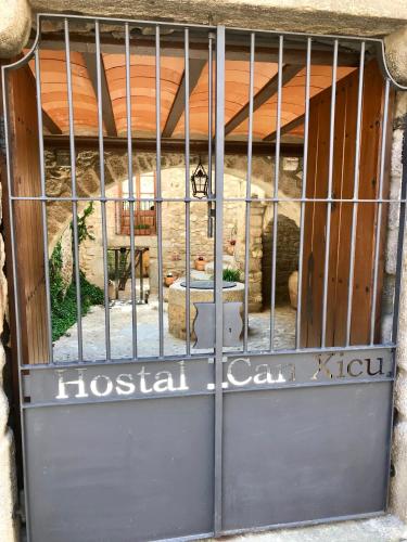 a door with a metal gate in a building at Hostal Can Xicu in Capmany