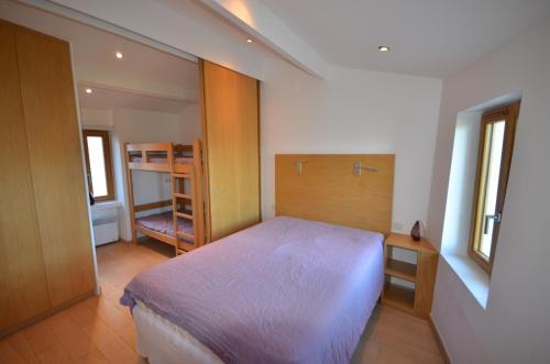a bedroom with a large bed in a room at Ramatuelle Maison de Village in Ramatuelle