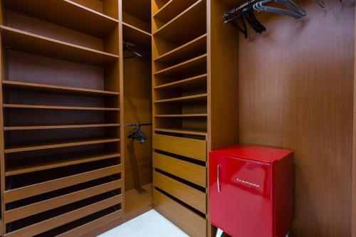 a red refrigerator in a walk in closet at Flor de Limão Hotel Boutique in Coroa Vermelha