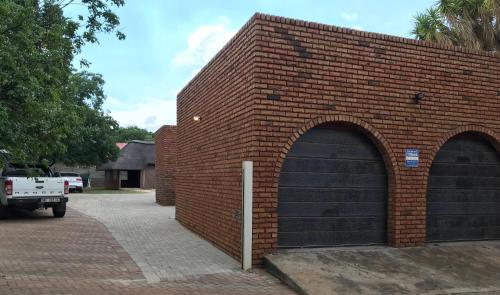 a brick building with two garage doors on it at 4 on Sirius in Polokwane