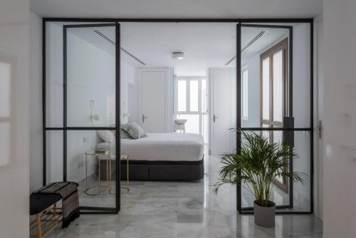 a bedroom with a bed and a large glass door at La casa del Lagar 10 in Seville