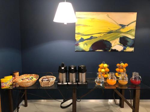 a table with a painting on the wall with fruit on it at Villa Regina in Riva del Garda