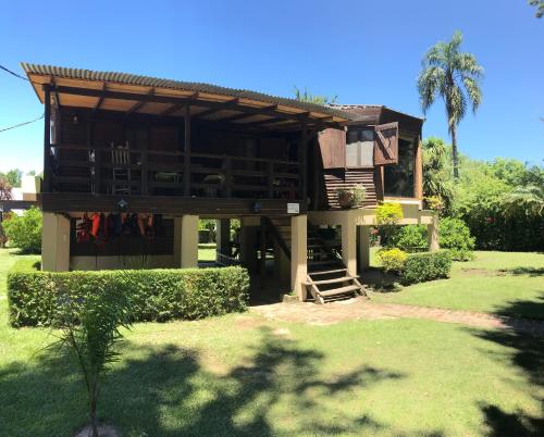a house with a porch and a staircase in a yard at Rio Manso Tigre in Tigre