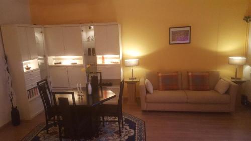 a living room with a couch and a table at Von-Thünen in Schwerin