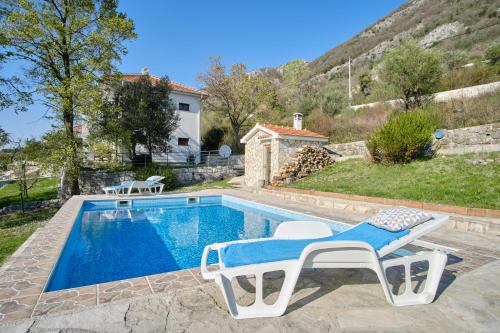 a villa with a swimming pool and a house at Villa Olga in Radanovići