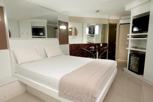 เตียงในห้องที่ Raru's Motel Via Costeira (Adult Only)