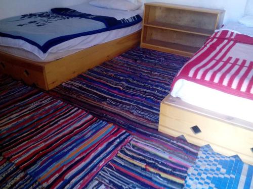 a bedroom with a bed and a rug on the floor at Sheikh Mousa Bedouin Camp in Saint Catherine