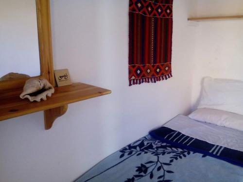 a bedroom with a bed and a mirror on a wall at Sheikh Mousa Bedouin Camp in Saint Catherine