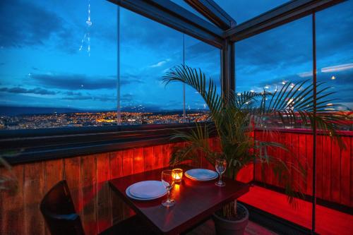 a table in a room with a view of a city at Urban Boutique Hotel in Tbilisi City