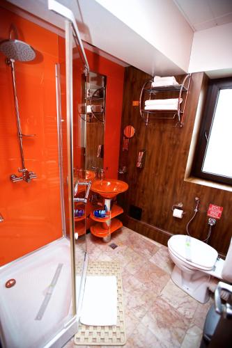 a bathroom with a shower and a toilet and a sink at LEGENDS Chambers by Grand Pier Boutique in Bucharest
