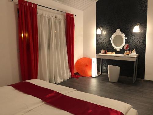 a bedroom with a bed and a table and a mirror at Pilot's Manor - Airport Villa in Velika Gorica