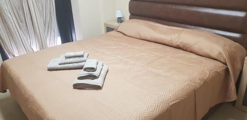 a bed with two towels and two remote controls on it at Casa Saphia de Melilla in Melilla
