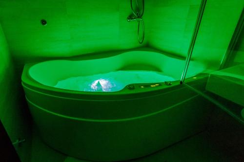 a green toilet in a bathroom with a green liquid at Luxury Budva Center Apartments in Budva