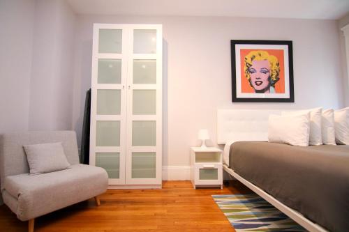a bedroom with a bed and a chair at A Stylish Stay w/ a Queen Bed, Heated Floors.. #25 in Brookline